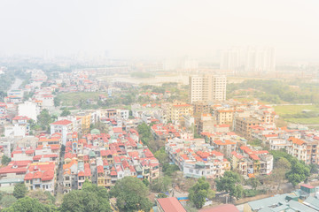 Fototapeta na wymiar Aerial view residential houses and high-rise condominium building in foggy background