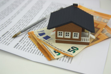 A house on some bills and some documents to sign