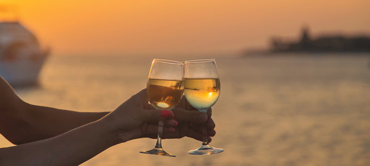 Drink wine by the sea. Selective focus.