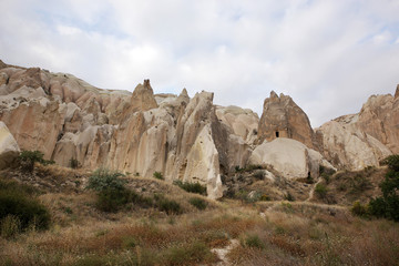 Fototapeta na wymiar Unusually shaped volcanic rocks in the Valley of Swords near the village of Goreme in the Cappadocia region of Turkey.