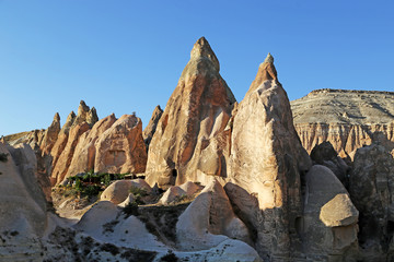 Unusually shaped volcanic rocks in the Pink Valley near the village of Goreme in the Cappadocia region of Turkey.
