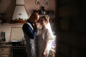 a couple in love in the kitchen.wedding photo of the bride and groom