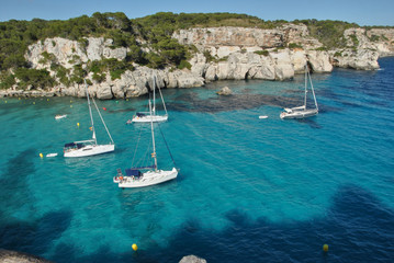 Fototapeta na wymiar Sailboats waiting in the calm and blue sea