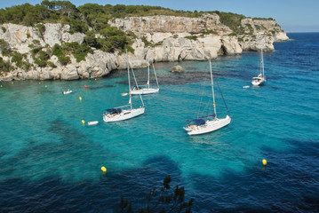 Fototapeta na wymiar Sailboats waiting in the calm and blue sea
