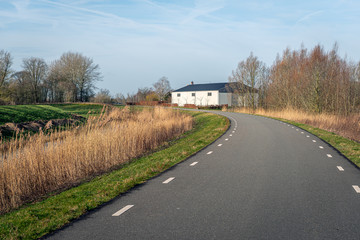 White barn on a curved country road