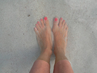 wet feet by the blue and calm sea