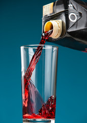 Cherry juice is poured from the packaging into a glass
