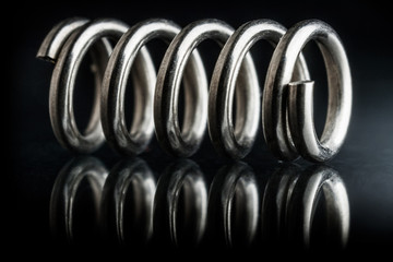 Steel spring reflection black background