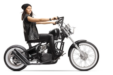 Fototapeta na wymiar Female biker on a custom black chopper