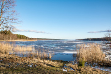 View of a frozen lake from a high bank