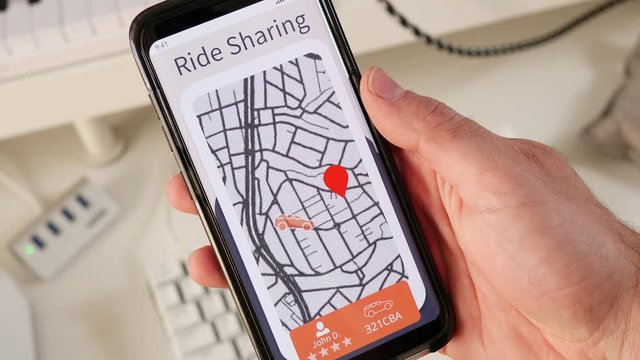 Using a ride sharing application on a mobile phone to request a car pickup. An interactive map showing a car approaching.