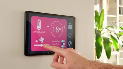 Controlling the temperature of the home using a smart house control panel screen. - Powered by Adobe