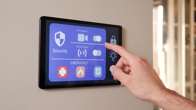 Smart house control panel screen with a hand setting the security options.