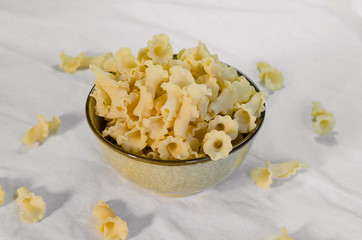 Gigli Pasta in Little Ceramic Bowl on White Fabic.
