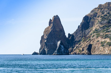 Fototapeta na wymiar Mountain landscape, large cliffs by the sea, beach, sunny day.