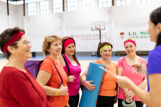 older women doing gymnastics and yoga in the ward with coach