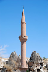 Fototapeta na wymiar fairy chimney rock village of Göreme in Cappadocia with rock houses and mosque is UNESCO world heritage site