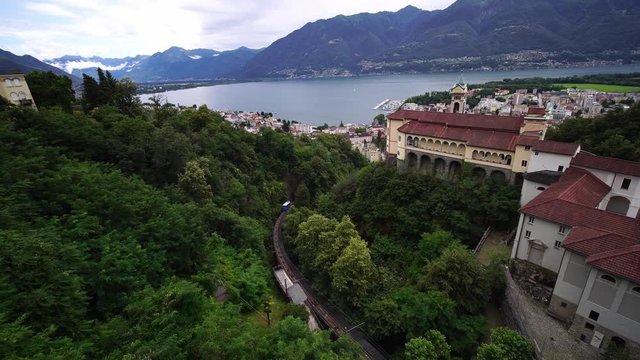 Panoramic view of Locarno, Madonna del Sasso mountain & funicular railcar train. Lake Maggiore. Ticino Switzerland. Swiss Alps. 4k