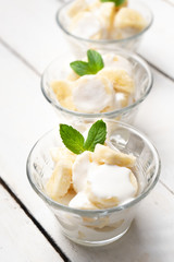 Banana with sour cream on white background
