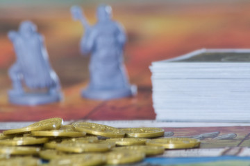 Board game with a deck of cards,  figures, and gold coins.