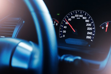 Driving car background. Speedometer speed indicator symbol. Dark elegant luxury car steering wheel....