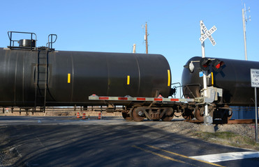 Fototapeta na wymiar Train Crossinb Oil Tanks