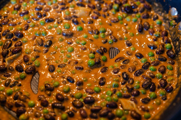 beans and peas cooking in a pan with salsa