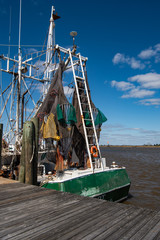 Fototapeta na wymiar Beautiful color fish netting hanging from a shrimp boat