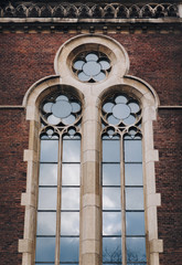 Round window with stained glass on facade of the building. Baroque and Gothic architecture. Church of St. Olga and Elizabeth. Lviv, Ukraine.
