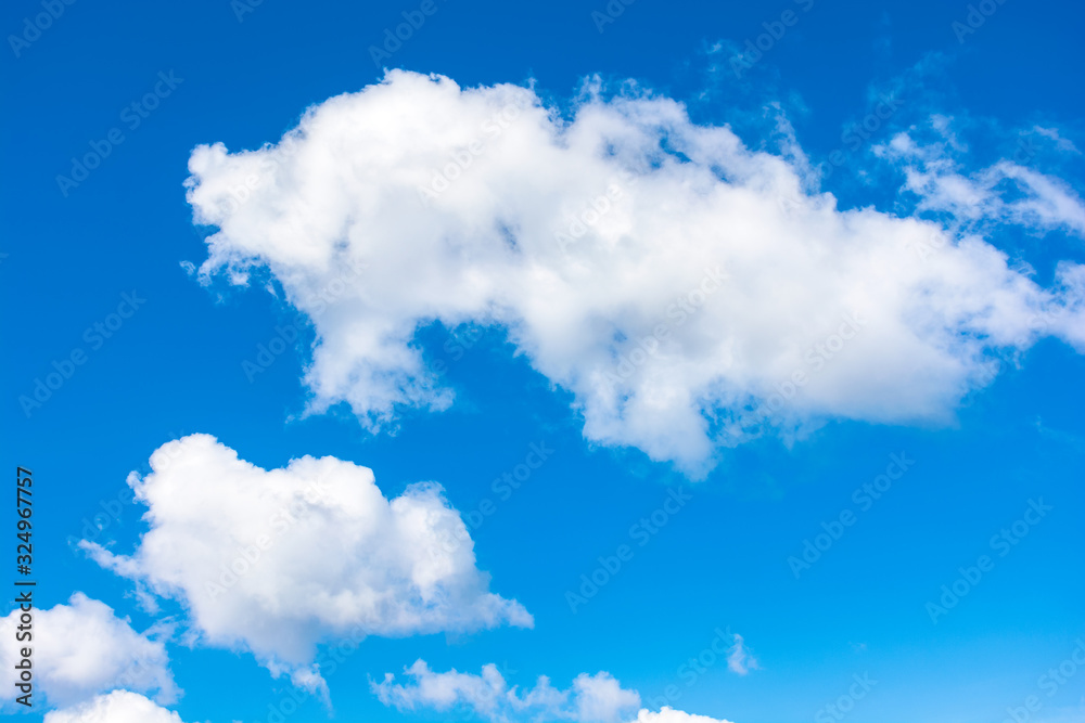 Wall mural gorgeous cloudscape in springtime. weather background with dynamic cloud arrangement on a blue sky. 