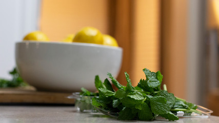 Lemons in a bowl with mint leaves