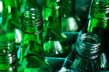 A shot of empy glass bottles ready to be recycled.