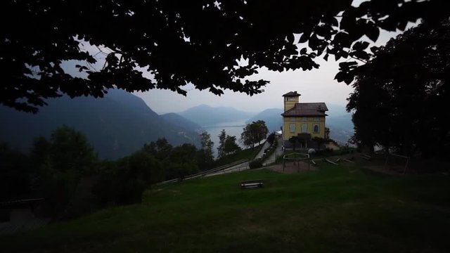 Monte Bre mountain top summit. Lake Lugano. Ticino, Switzerland summer tourism. Slow motion.