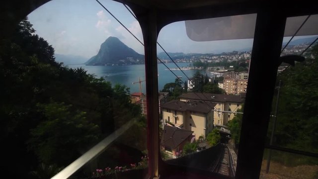 Views of Lake Lugano from Monte Bre funicular train, Funicolare Cassarate railway. Ticino, Switzerland summer tourism. 