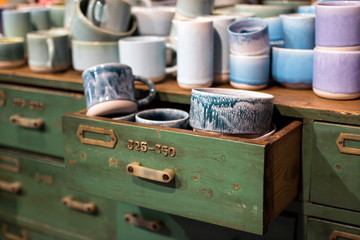 White ceramic plates on a shelf in a store.