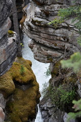 Rocks leaning over water
