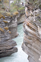 Worn mountain side with water running through