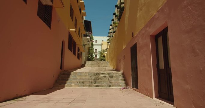 Tilt up on colored building line a narrow street in Old San Juan Puerto Rico