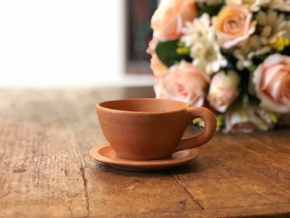 Brown clay teacup on wooden table