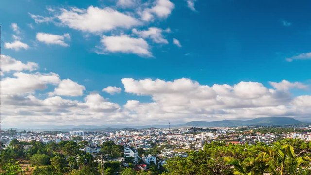Time lapse Dalat cityscape the eternal spring city in Vietnam green urban parks highland mountains plateau famous for coffee strawberry agriculture dramatic clouds and blue sky