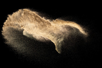 Fototapeta na wymiar Brown colored sand splash.Dry river sand explosion isolated on black background. Abstract sand cloud.