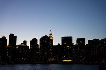 New York City skyline at night with lights on