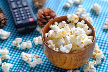 top view of popcorn and tv remote on table