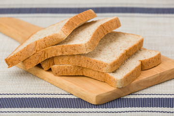 Whole wheat bread on a wooden plate