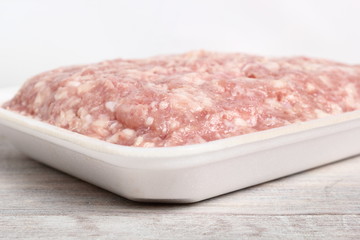 Ground chicken in polystyrene food tray