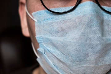 Close up of asian man in facial mask and glasses. Virus infection in china concept. Pandemic disease. Virus protection concept. Chinese coronavirus outbreak.