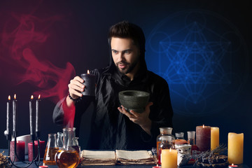 Male alchemist making potion on dark background