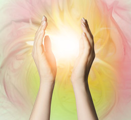 Female hands with shining energy on color background