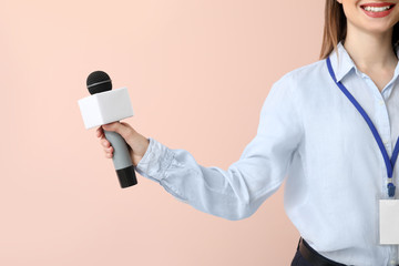 Female journalist on color background