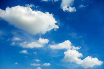 White stacked clouds against a blue sky background